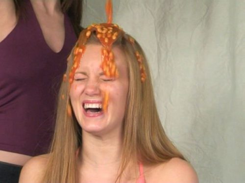 Girl has baked beans poured over her head.